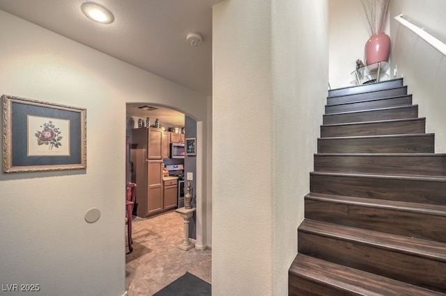 stairs featuring vaulted ceiling