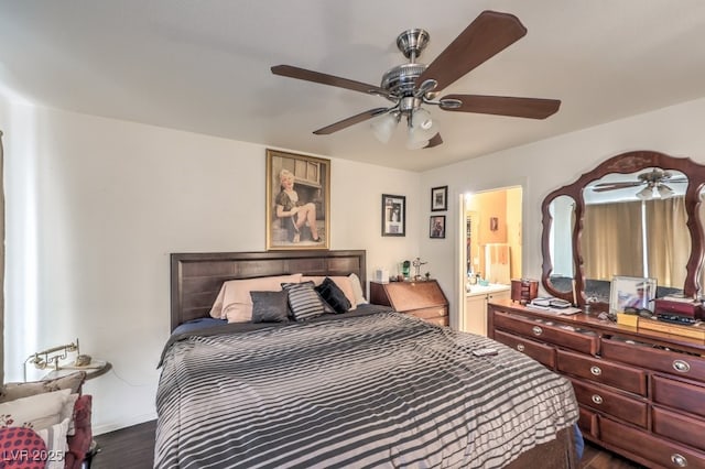 bedroom featuring ceiling fan, ensuite bathroom, and dark hardwood / wood-style floors