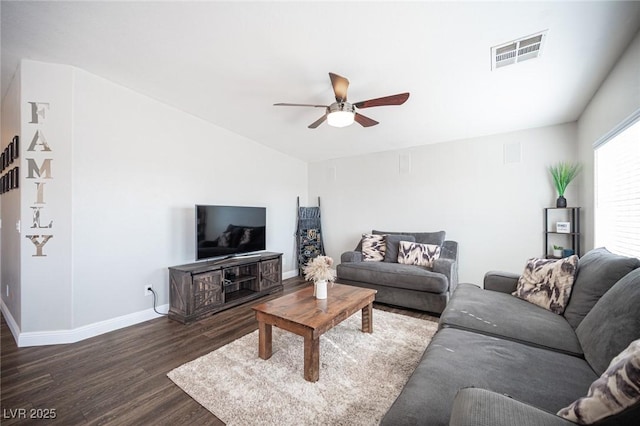 living room featuring dark wood-type flooring and ceiling fan