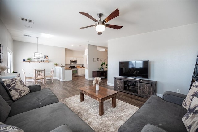 living room featuring ceiling fan and dark hardwood / wood-style flooring