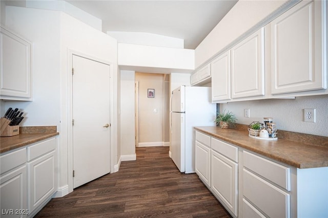 kitchen with dark hardwood / wood-style floors, white cabinets, and white fridge