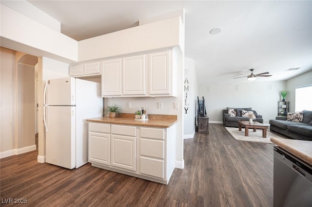 kitchen with stainless steel dishwasher, dark hardwood / wood-style floors, white fridge, and white cabinets