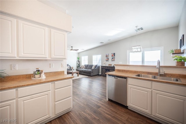 kitchen featuring white cabinetry, sink, dark hardwood / wood-style flooring, hanging light fixtures, and stainless steel dishwasher