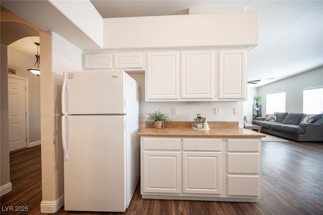 kitchen with dark hardwood / wood-style flooring, white cabinetry, and white refrigerator