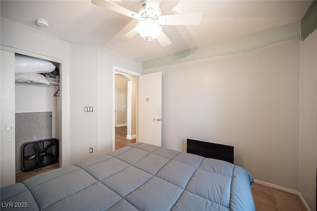 bedroom with a closet, ceiling fan, and carpet