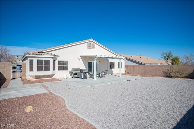 back of property with a patio