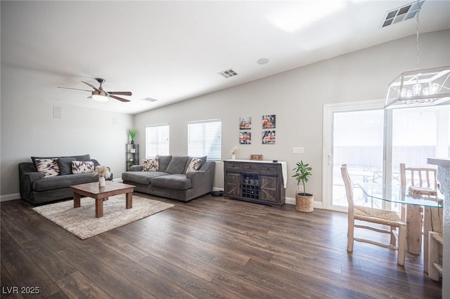 living room with ceiling fan and dark hardwood / wood-style flooring