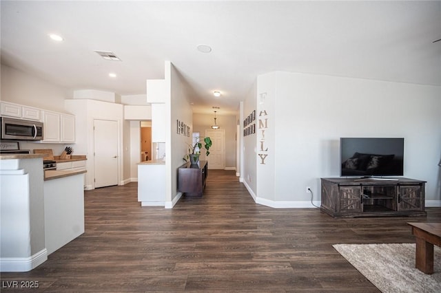 kitchen featuring white cabinetry and dark hardwood / wood-style floors