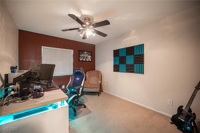 carpeted office space with ceiling fan