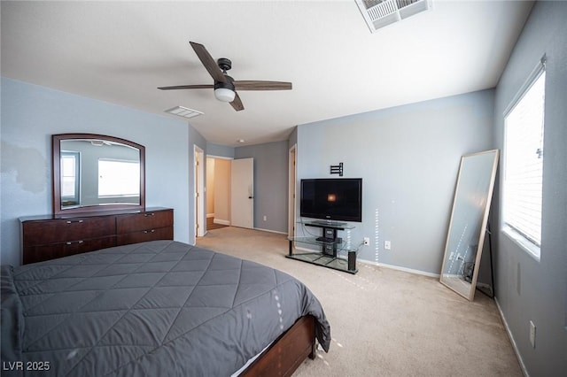 bedroom featuring ceiling fan, light colored carpet, and multiple windows