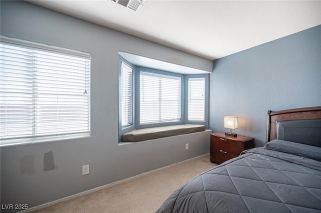 bedroom featuring light colored carpet