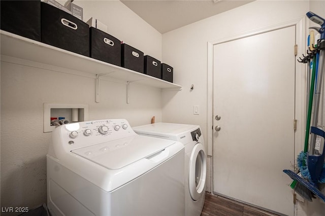 clothes washing area featuring separate washer and dryer and dark hardwood / wood-style flooring