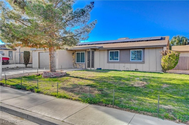 4512 Mark Ave, Las Vegas, NV 89108 - ranch-style house with board and batten siding, a garage, and roof mounted solar panels