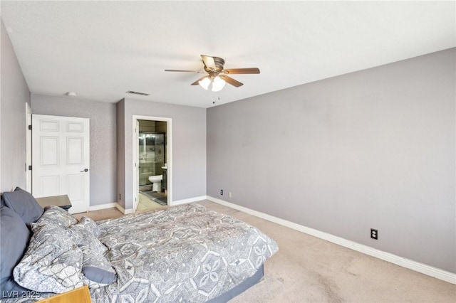 bedroom with ceiling fan, connected bathroom, and light carpet