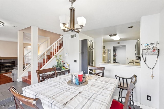 dining room featuring hardwood / wood-style floors and a chandelier