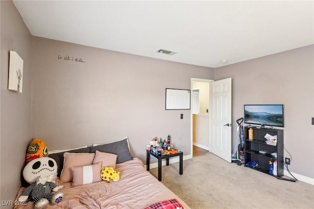 bedroom featuring light colored carpet