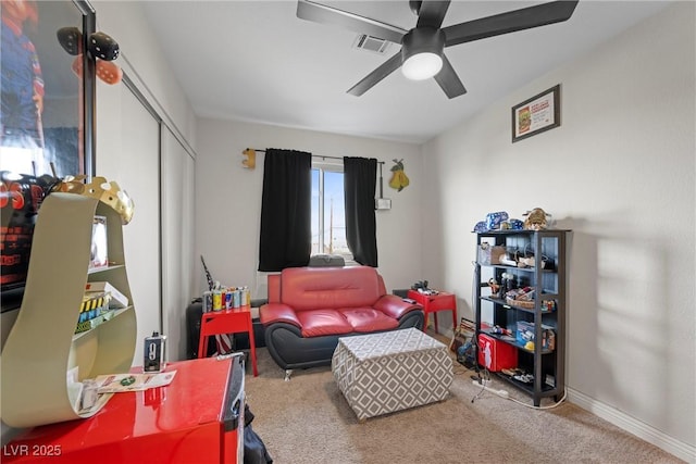 living area featuring light colored carpet and ceiling fan