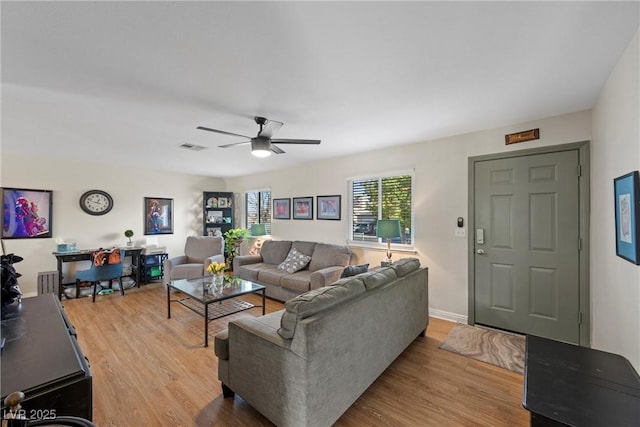 living room with ceiling fan and light hardwood / wood-style floors