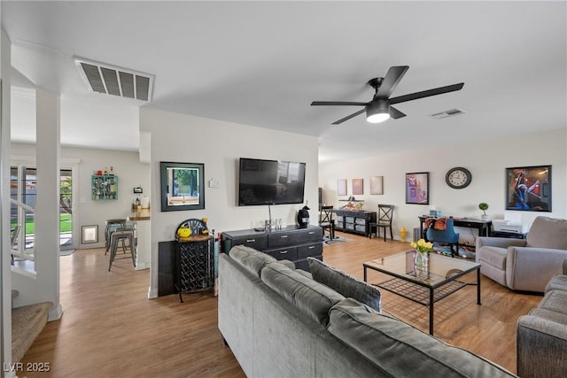 living room with hardwood / wood-style floors and ceiling fan