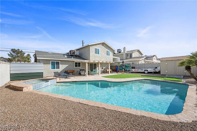 view of pool with an in ground hot tub, a storage unit, central AC unit, and a patio area