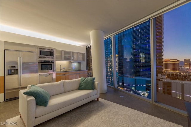 living room featuring sink and a wall of windows