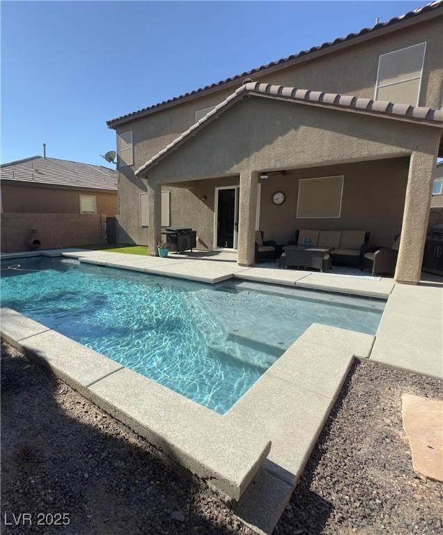 view of pool with outdoor lounge area and a patio