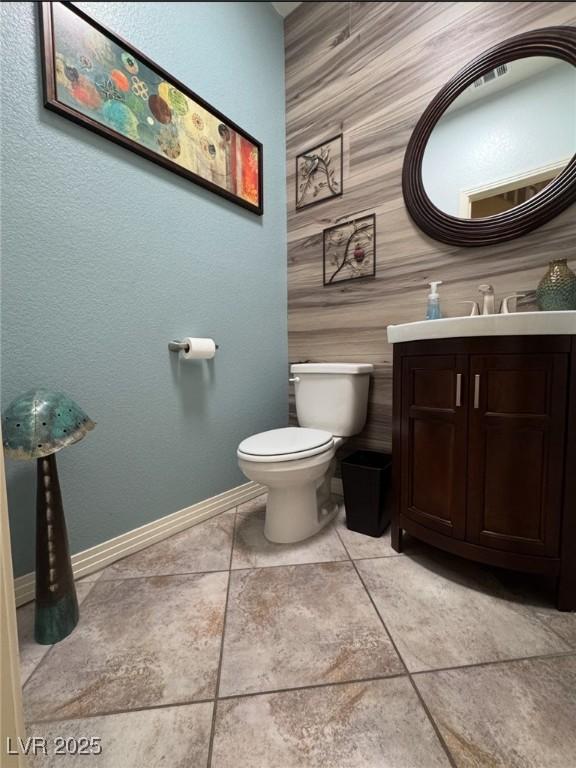 bathroom featuring vanity, tile patterned floors, and toilet