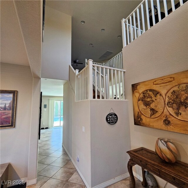 staircase featuring tile patterned flooring