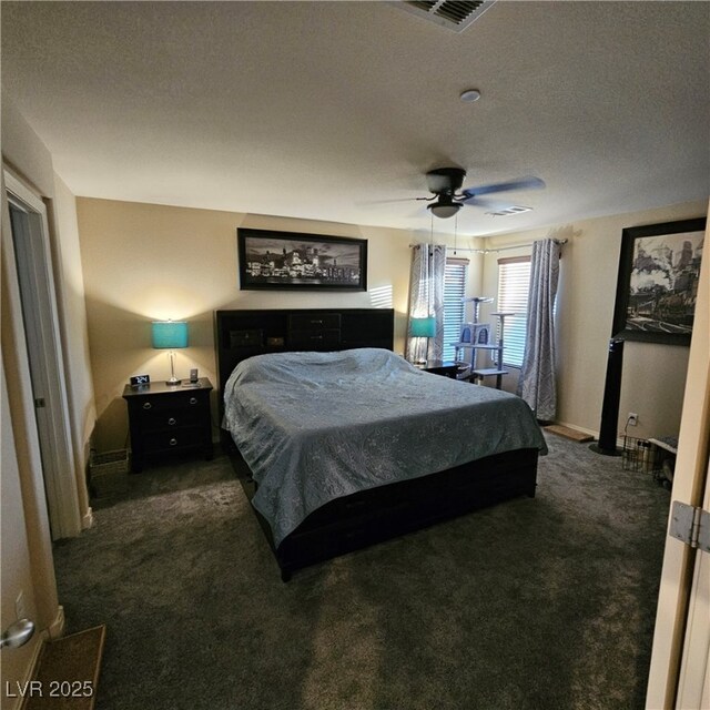 carpeted bedroom featuring a textured ceiling and ceiling fan