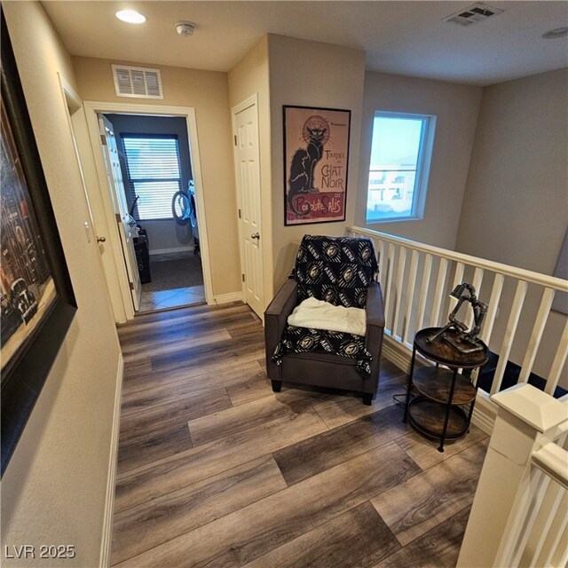 sitting room featuring a healthy amount of sunlight and dark hardwood / wood-style flooring