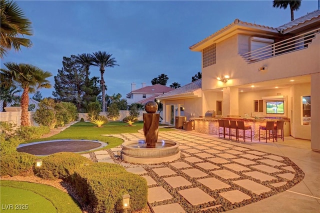 exterior space featuring a patio area and an outdoor bar