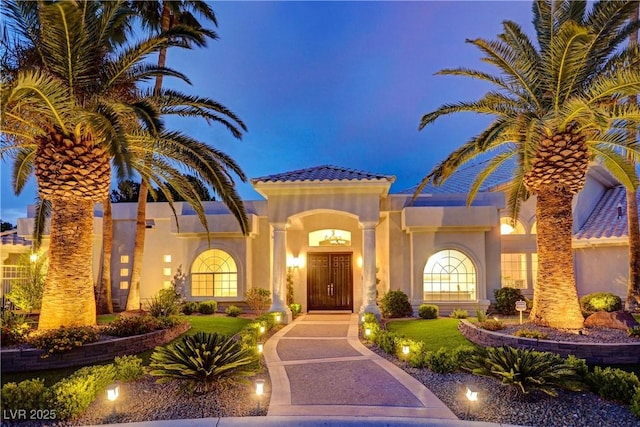 mediterranean / spanish house featuring a front yard