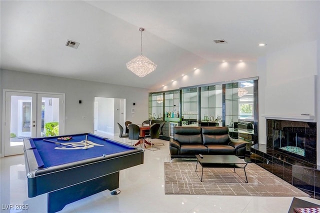 recreation room featuring lofted ceiling, a high end fireplace, billiards, and french doors