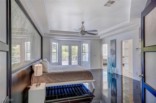 tiled bedroom featuring french doors, access to exterior, ceiling fan, and a tray ceiling