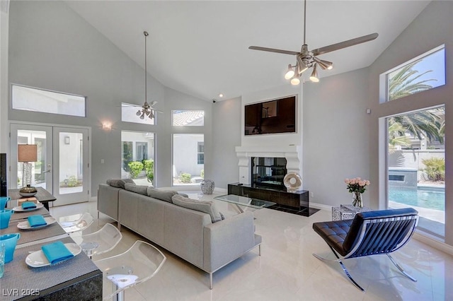 living room with french doors, ceiling fan, a healthy amount of sunlight, and high vaulted ceiling