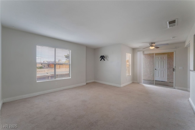 unfurnished room featuring light carpet and ceiling fan