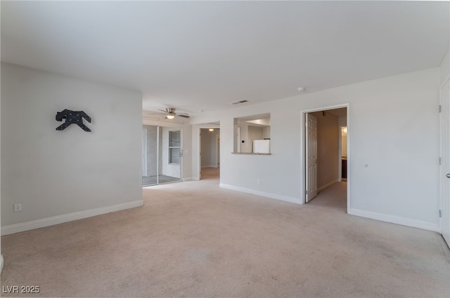 unfurnished living room featuring light carpet and ceiling fan