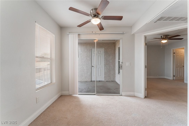 unfurnished bedroom with ceiling fan, light colored carpet, and access to exterior