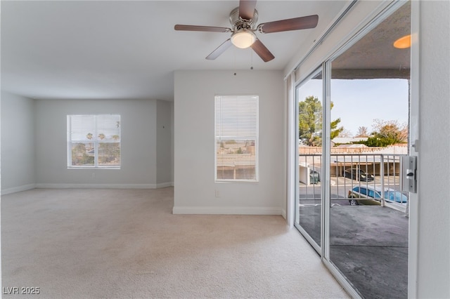 carpeted empty room featuring ceiling fan