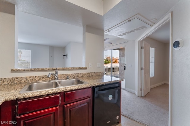 kitchen featuring light carpet, black dishwasher, sink, and kitchen peninsula