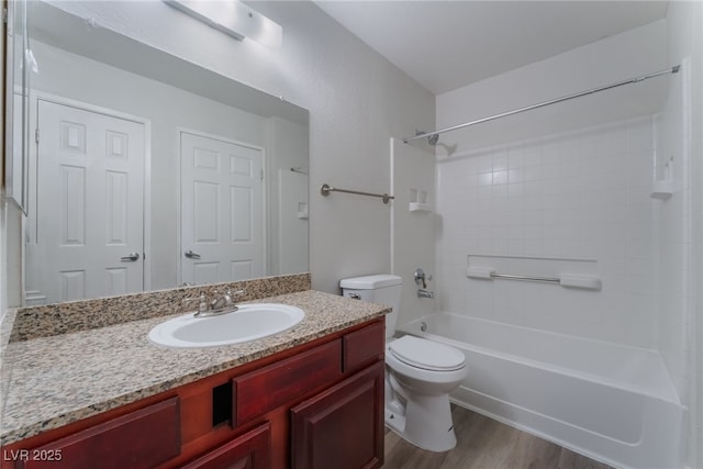 full bathroom with shower / bathing tub combination, hardwood / wood-style floors, vanity, and toilet