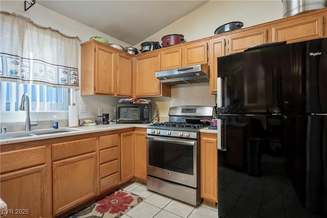 kitchen featuring vaulted ceiling, sink, light tile patterned floors, and black appliances