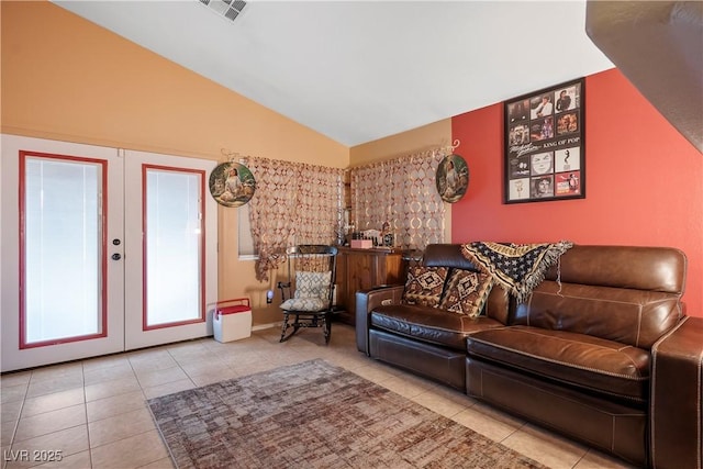 living room with vaulted ceiling, french doors, and light tile patterned flooring