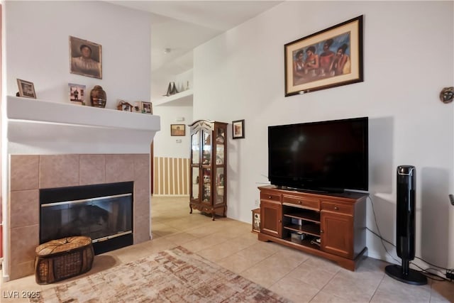 tiled living room featuring a fireplace