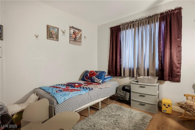 bedroom with hardwood / wood-style floors