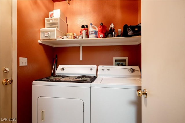 clothes washing area with washer and clothes dryer