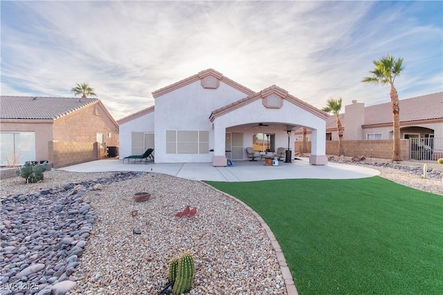 back of house with a yard, central AC, a patio, and ceiling fan