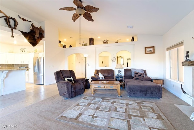 living room featuring lofted ceiling, light carpet, and ceiling fan