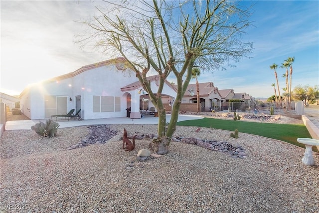 back of house featuring a patio and a yard