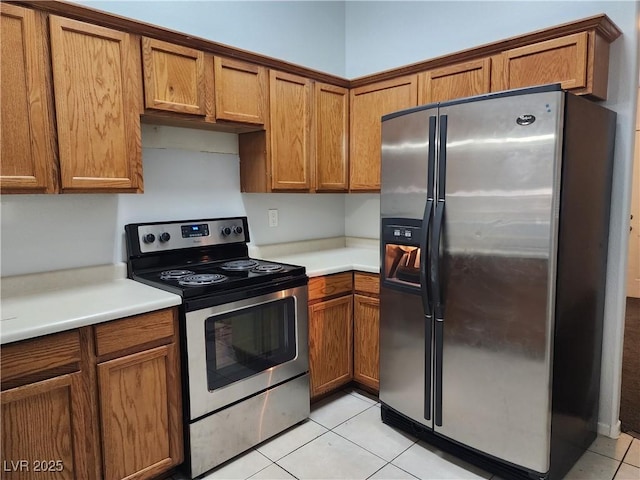 kitchen featuring appliances with stainless steel finishes and light tile patterned floors